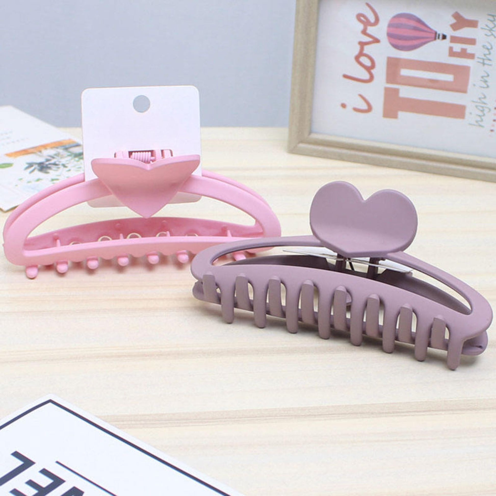 Two hair clips, one pink and one purple,